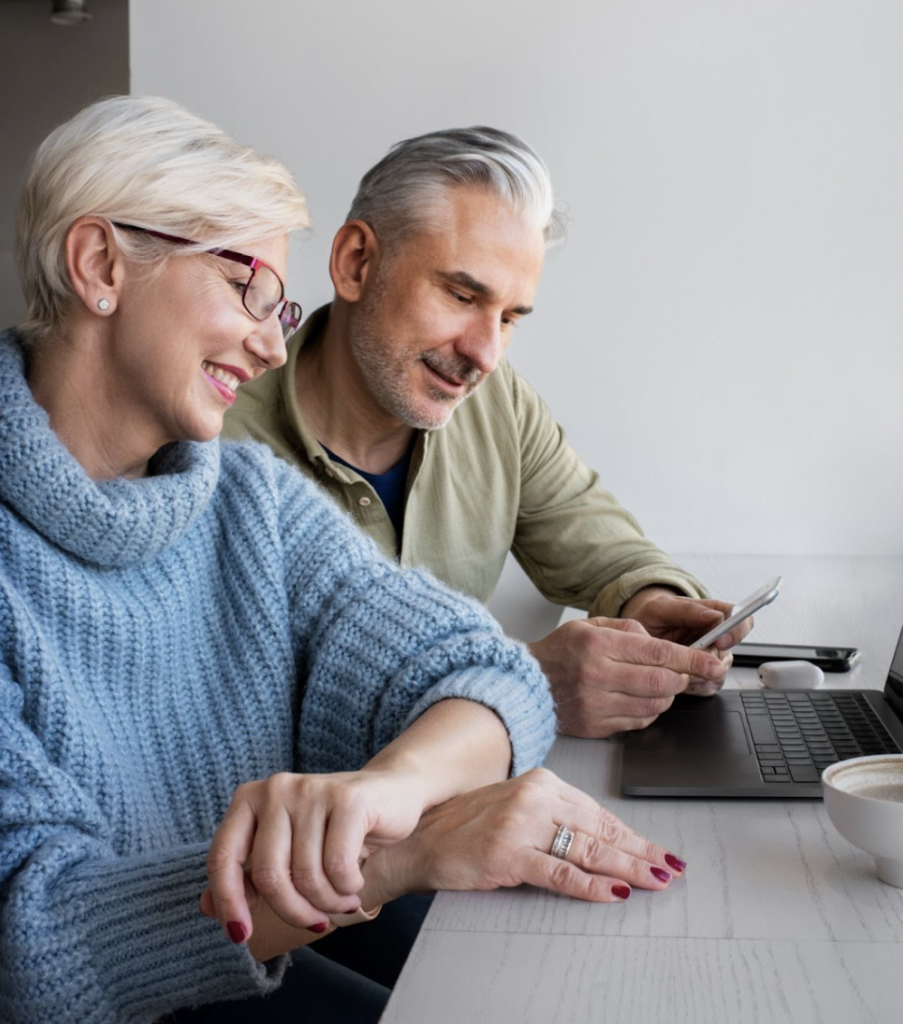 Happy couple researching ways to build equity in their home to pay off debts, fund their retirement, and unlock cash for new opportunities